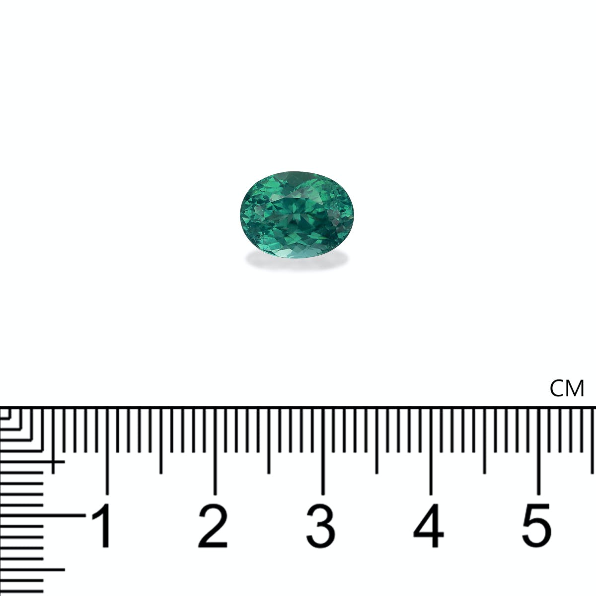 Une petite pierre précieuse verte de forme ovale, la Tourmaline Paraïba · 3,6ct de Bonnot Paris, est placée au-dessus d'une règle graduée en centimètres, mesurant environ 1,5 cm de longueur sur fond blanc.