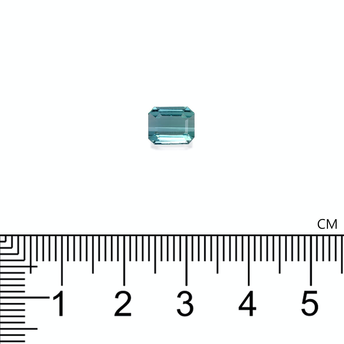 Une petite pierre précieuse rectangulaire Tourmaline Bleue · 1,47 ct de Bonnot Paris est placée sur un fond blanc au-dessus d'un gros plan d'une règle centimétrique qui montre qu'elle mesure moins de 1 cm de longueur.