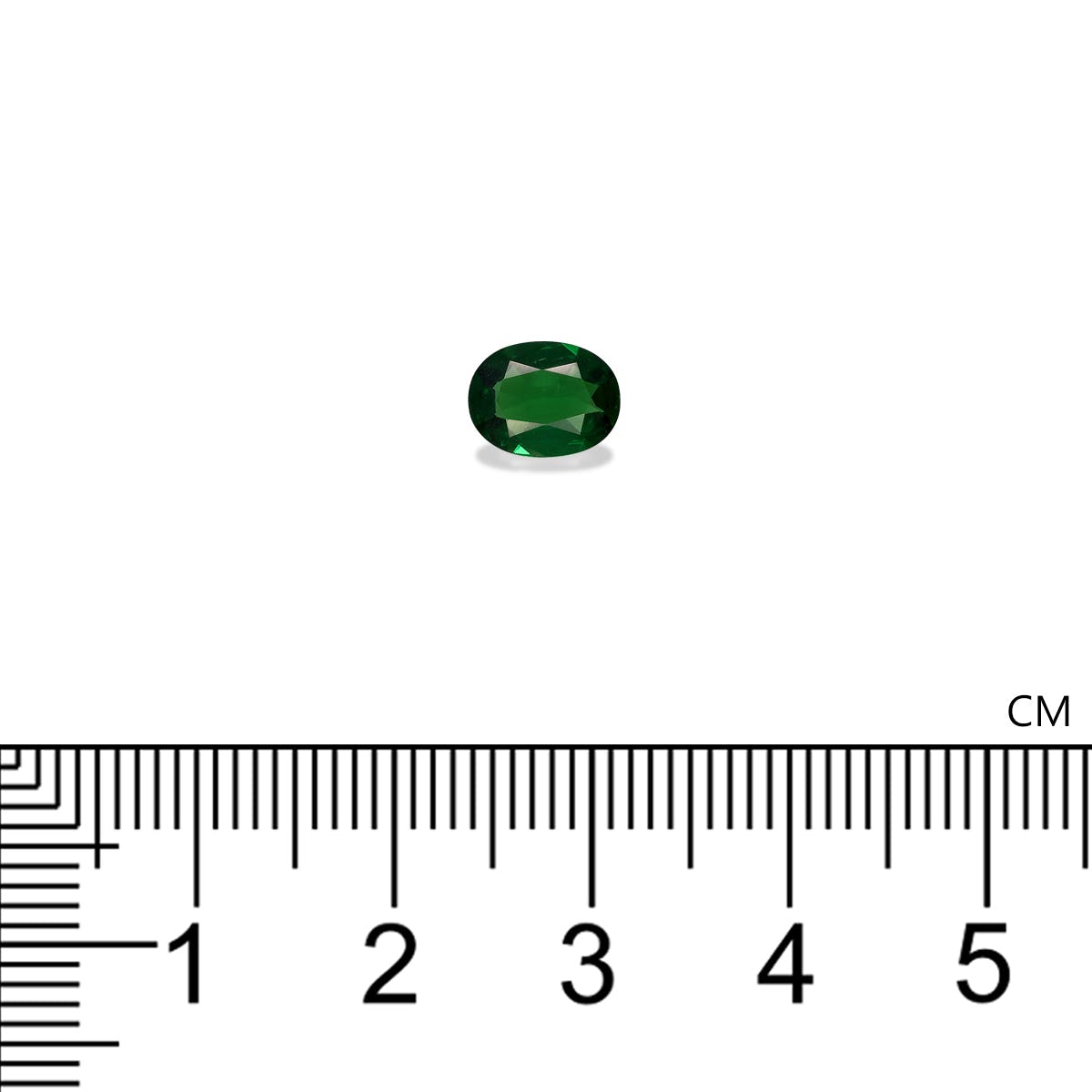 Le Grenat Tsavorite Bonnot Paris, une pierre précieuse verte ovale pesant 0,88 ct, est présenté sur un fond blanc au-dessus d'une règle centimétrique, mesurant environ 0,7 cm de longueur.
