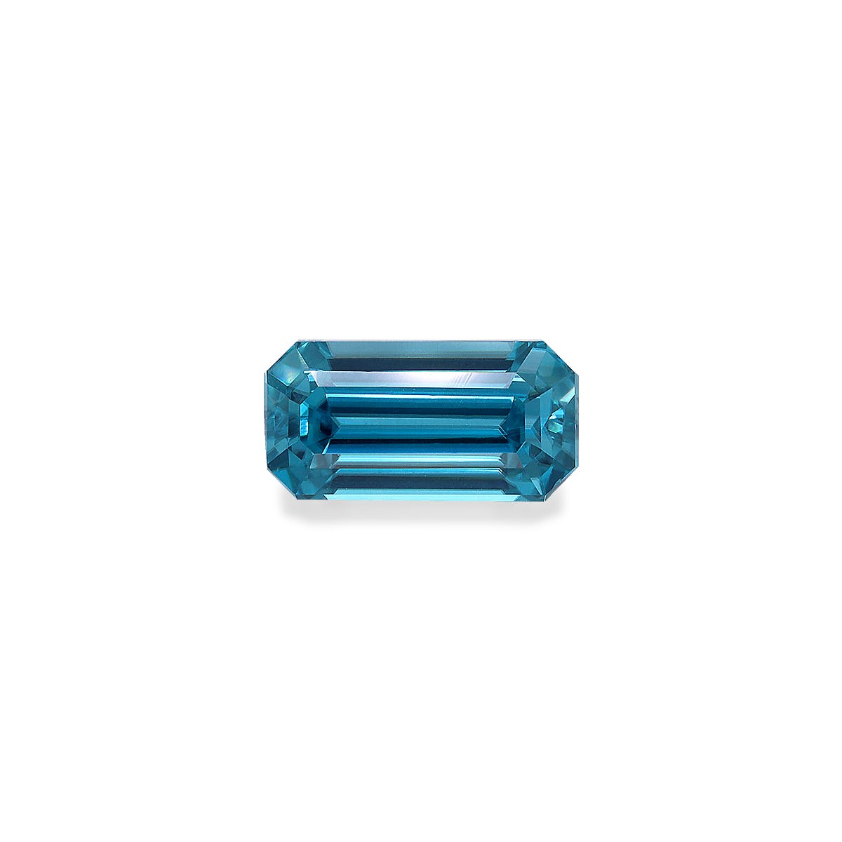 Une pierre précieuse Zircon Bleu rectangulaire allongée facettée de 4,44 ct avec des bords biseautés par Bonnot Paris, reflétant la lumière sur un fond blanc uni.