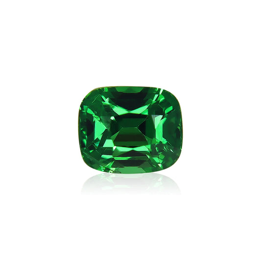La Grenat Tsavorite de Bonnot Paris, une pierre précieuse vibrante taille coussin de 1,55 ct, présente des facettes qui reflètent magnifiquement la lumière sur un fond blanc uni, mettant en valeur sa couleur verte brillante et sa clarté.