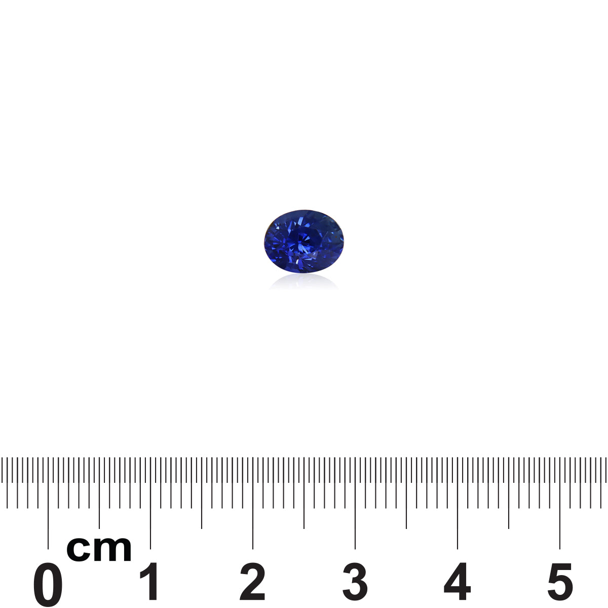 Le Saphir Bleu · 2,12 ct de Bonnot Paris est une petite pierre précieuse bleu foncé ronde et légèrement réfléchissante centrée au-dessus d'une règle métrique affichant des mesures en centimètres sur un fond blanc.