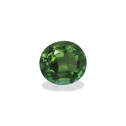 La Tourmaline Verte · 6,67ct de Bonnot Paris est une gemme verte ronde et facettée sertie sur un fond neutre, soulignant son éclat et sa clarté.