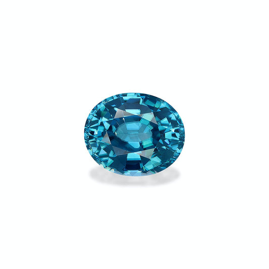 Le Zircon Bleu · 7,49 carats de Bonnot Paris est présenté au centre sur un fond blanc, mettant en valeur sa pierre bleue ronde et facettée. Ses tailles complexes offrent un jeu saisissant de bleu clair et foncé, soulignant sa clarté et son éclat.